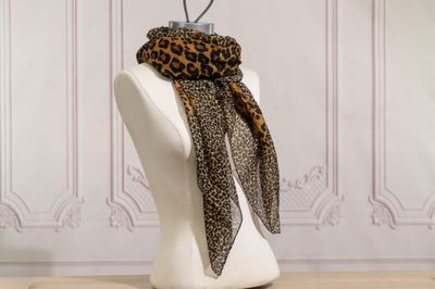 a mannequin with a leopard print scarf on it