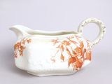 a white and orange gravy with orange flowers on it