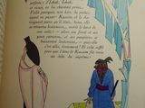 an open book with a drawing of a man and a woman standing in front of a palm tree