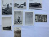 several old black and white photos of people and vehicles on a wall