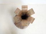 a brown vase that has a black hole in it