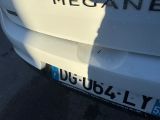 a close up of a white car with the word megaane written on it