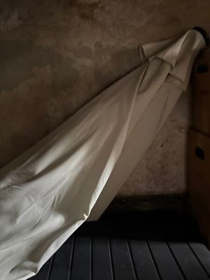 un drap blanc accroché au mur à côté d'une commode