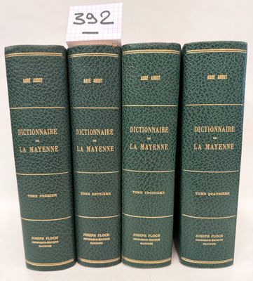 three green books are stacked on top of each other on a white surface