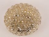 a silver ball with a lot of beads on it
