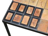 a table that has a bunch of tiles on top of it