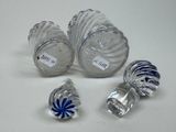 three glass vases with blue and white designs are on a table