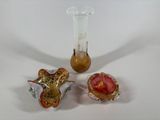 three glass vases sitting next to each other on a table