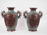 pair of antique vases with horses on them on a white background