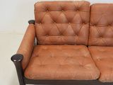 a brown leather couch that is sitting in a room