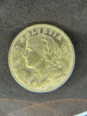 l'image d'une pièce d'or sur laquelle figure le visage d'une femme