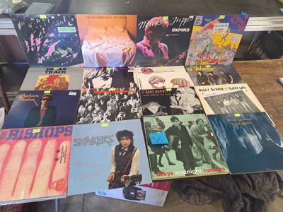 a lot of records sitting on a table in a room