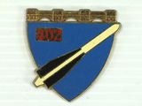the badge is blue and gold with a sword on it