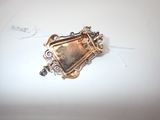 a small metal object on a white surface