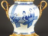 un vase bleu et blanc orné de motifs dorés