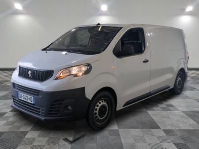 the white van is parked in a large room with a checkered floor