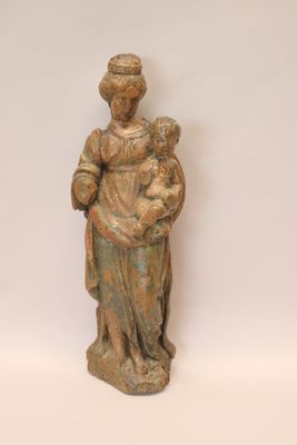 an old statue of a woman holding a child in her arms