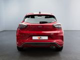 the rear end of a red ford fiesta parked in a showroom