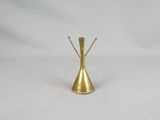 a gold colored metal vase with a stem sticking out of it
