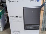 a box that is sitting on the floor in front of a shelf