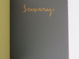 an open book with a yellow cover sitting on top of a white table
