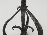 wrought iron candle holder with a twisted design on a white background