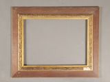 an old picture frame hanging on a wall in a room