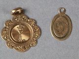 two gold medals with a picture of a woman on them