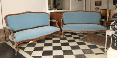 two couches and a chair in a room with a checkered floor