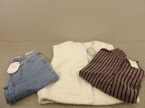 three pairs of clothes are laid out on a table