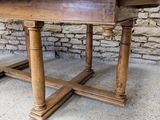 an old wooden table with two legs and a wooden top