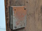 a close up of a wooden door with a metal latch