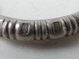 an image of a silver bracelet that has a number of small beads on it