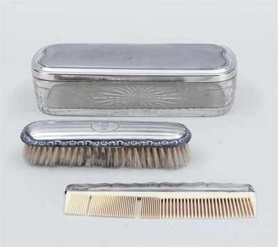 two combs and a brush sitting next to each other