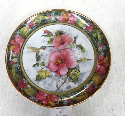 a picture of a plate with a humming and flowers on it