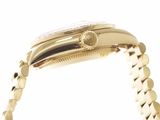 a close up of a gold watch with a chain around it