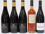 six bottles of wine are lined up in a row on a white surface