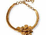 a close up of a gold bracelet on a white background
