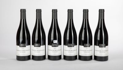 six bottles of wine are lined up in a row