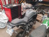 a motorcycle that is parked in a garage next to other motorcycles