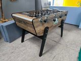 a foosball table in the corner of a room