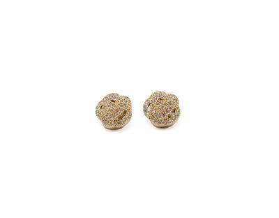 a pair of earrings with gold and white stones