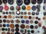 many different types of buttons displayed on the wall