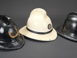 three black and white hats sitting next to each other on a table