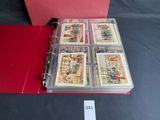 a red binder with a lot of cards inside of it