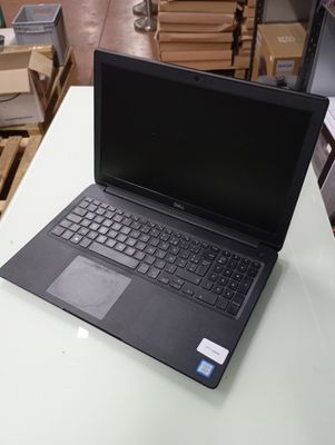 a laptop computer sitting on a table in a warehouse
