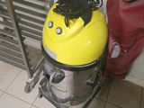 un aspirateur jaune et noir posé par terre à côté d'un sac rouge