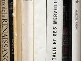 many books that are on a shelf in a book case