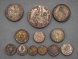 a group of coins sitting on top of a table next to each other