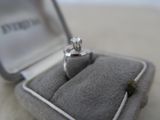 a diamond ring sitting in a ring box on a table
